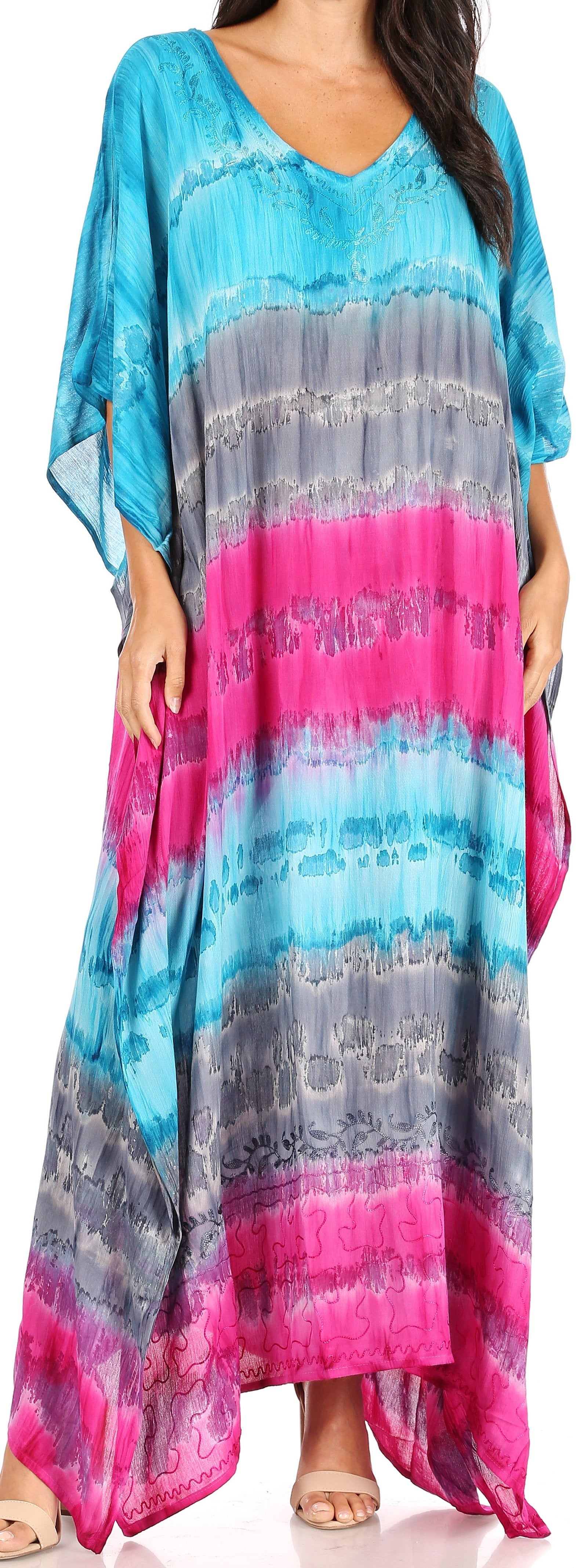 Woman wearing a colorful tie-dye dress with blue, gray, and pink gradient.