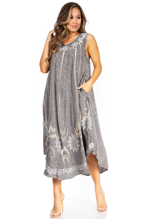 Woman wearing a gray sleeveless dress with floral patterns on a white background