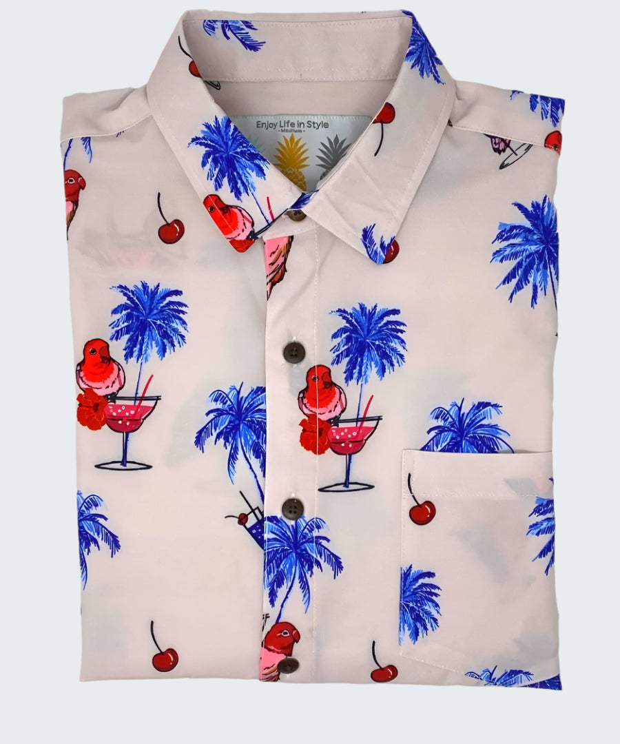 Shirt with tropical pattern featuring palm trees, cherries, and cocktails on a white background