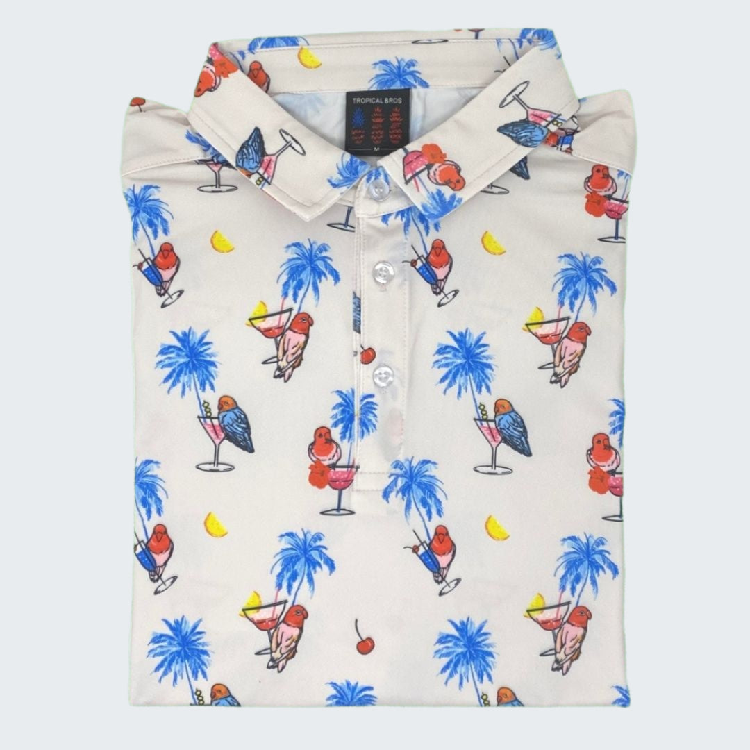 White polo shirt with colorful tropical pattern on a green background