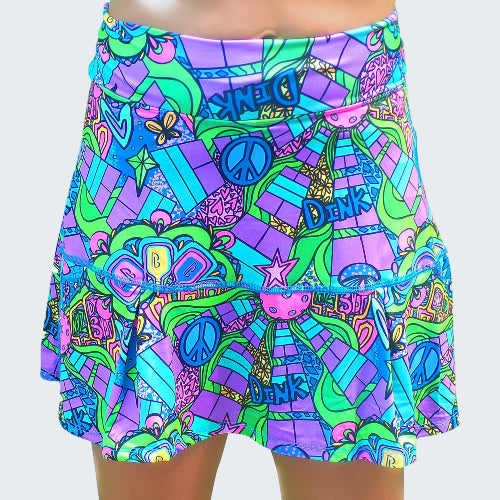 Colorful patterned skirt with peace signs and abstract designs on a white background