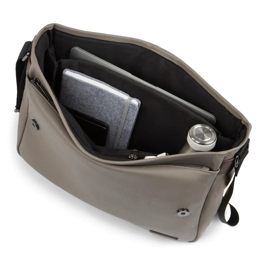 Open beige handbag with a laptop and water bottle on a white background