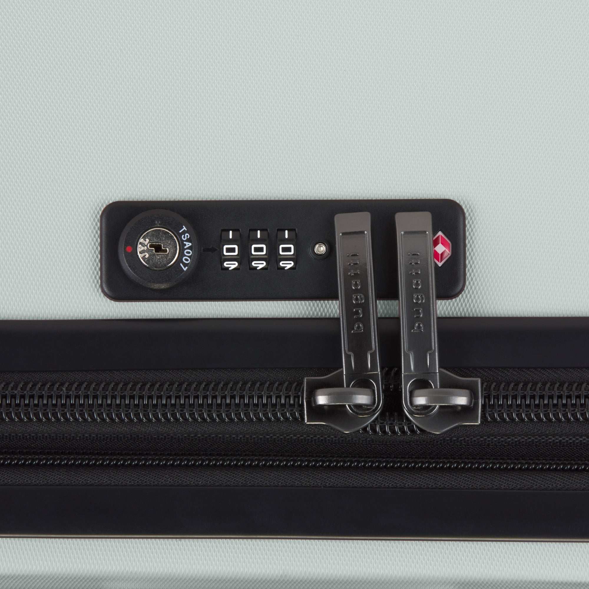 Close-up of a suitcase with a combination lock on a light gray background