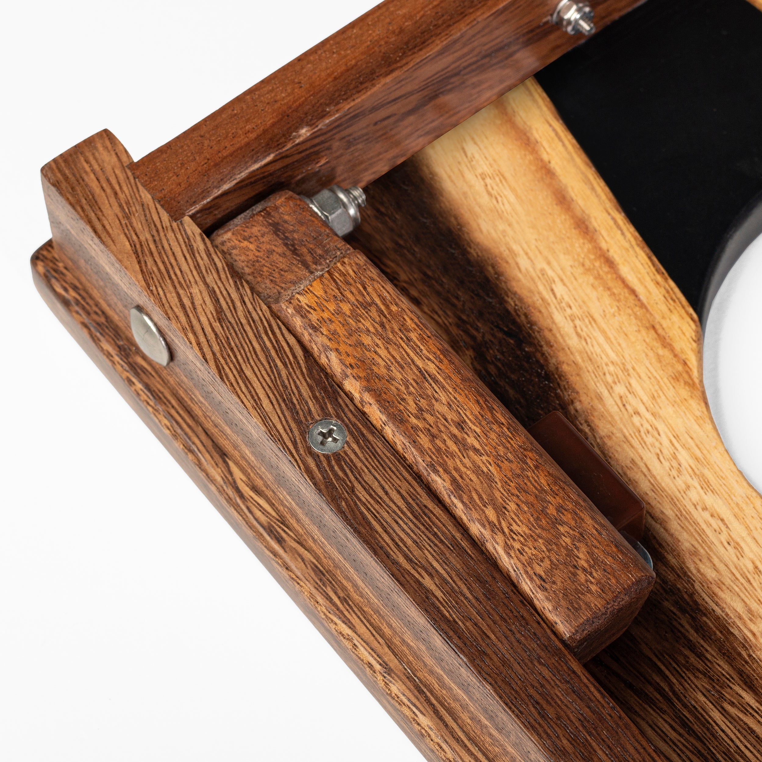 Close-up of a wooden tool with a white object inside on a white background