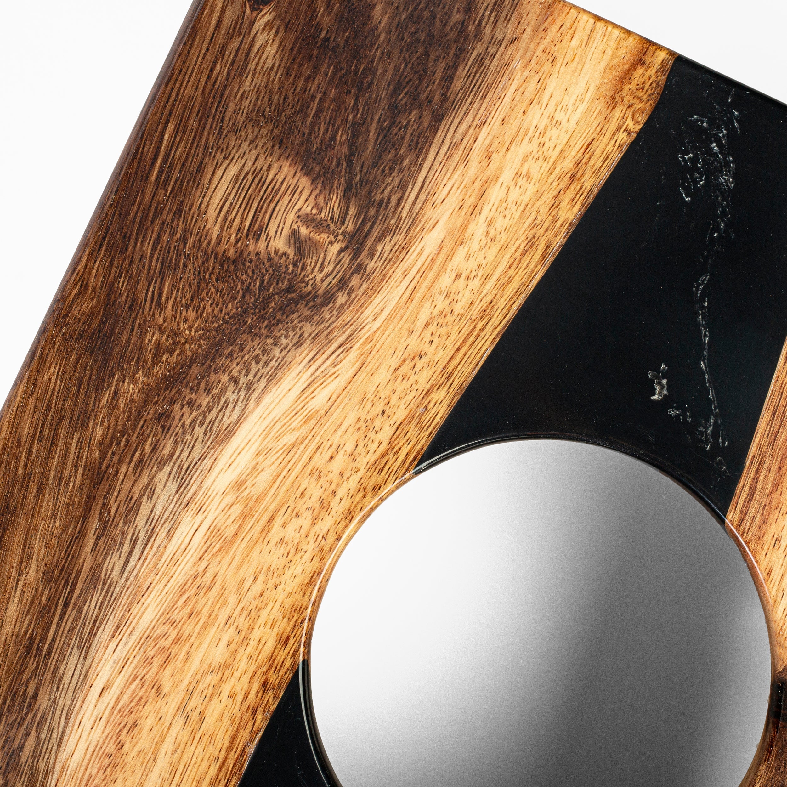 Round mirror with wooden frame on a white background