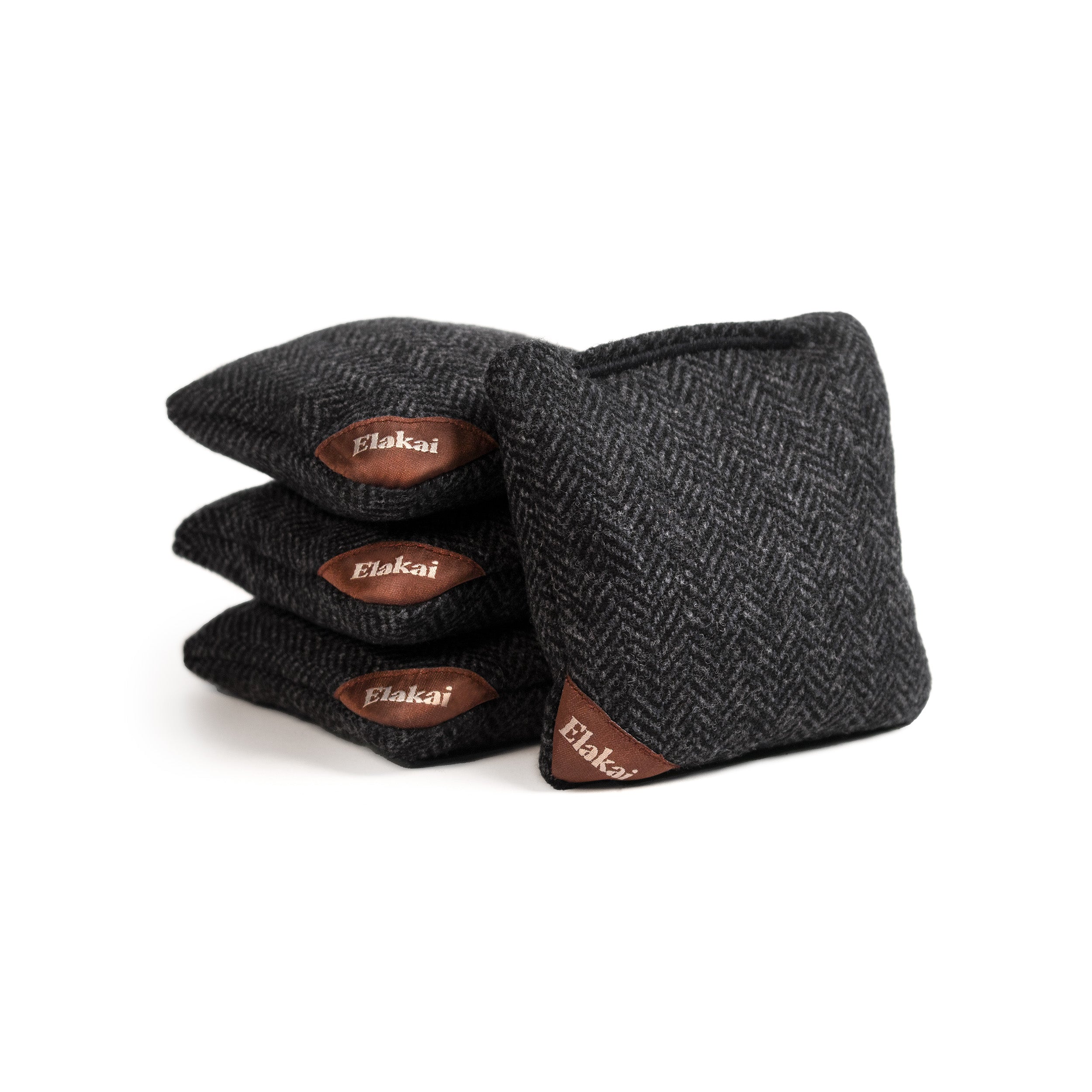 Pair of black herringbone gloves with brown leather accents on a white background