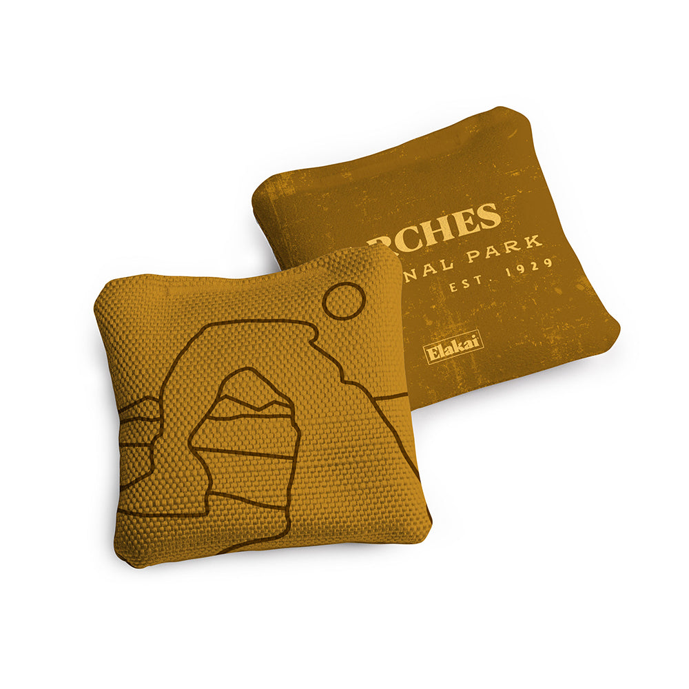 Two brown bean bags with a design of a arch and text on a white background