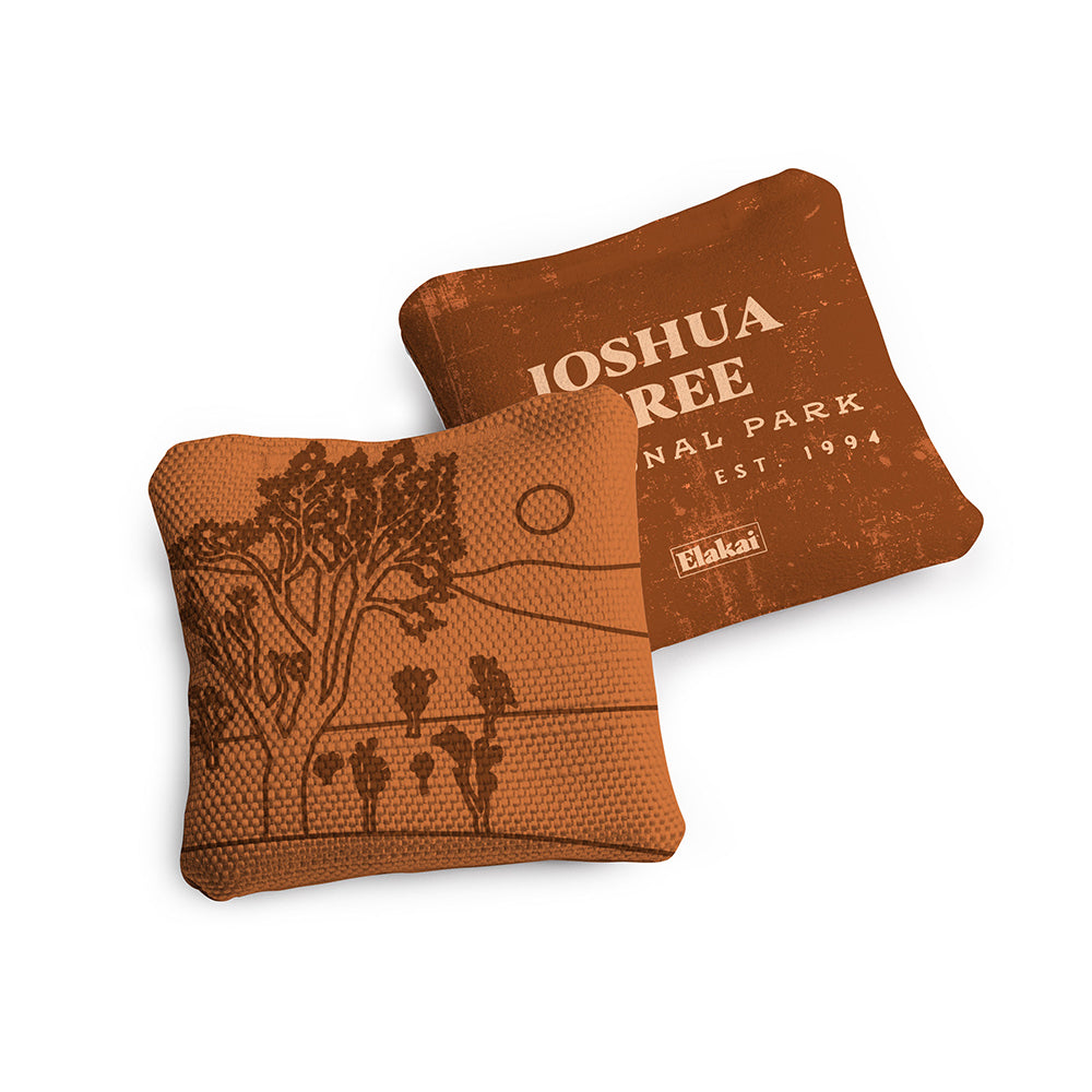 Two brown pillows with 'Joshua Tree National Park' design on a white background