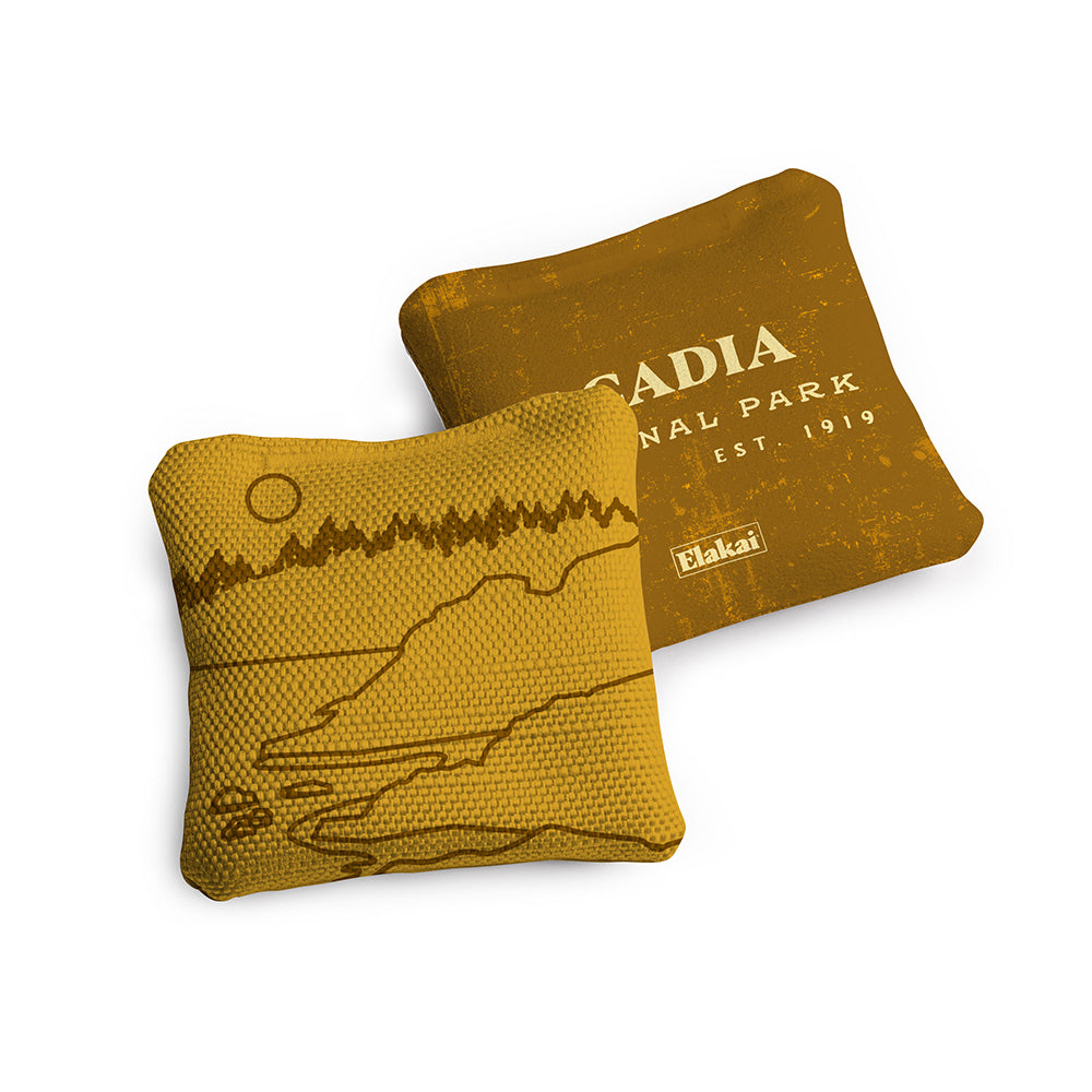 Two yellow pillows with mountain designs on a white background