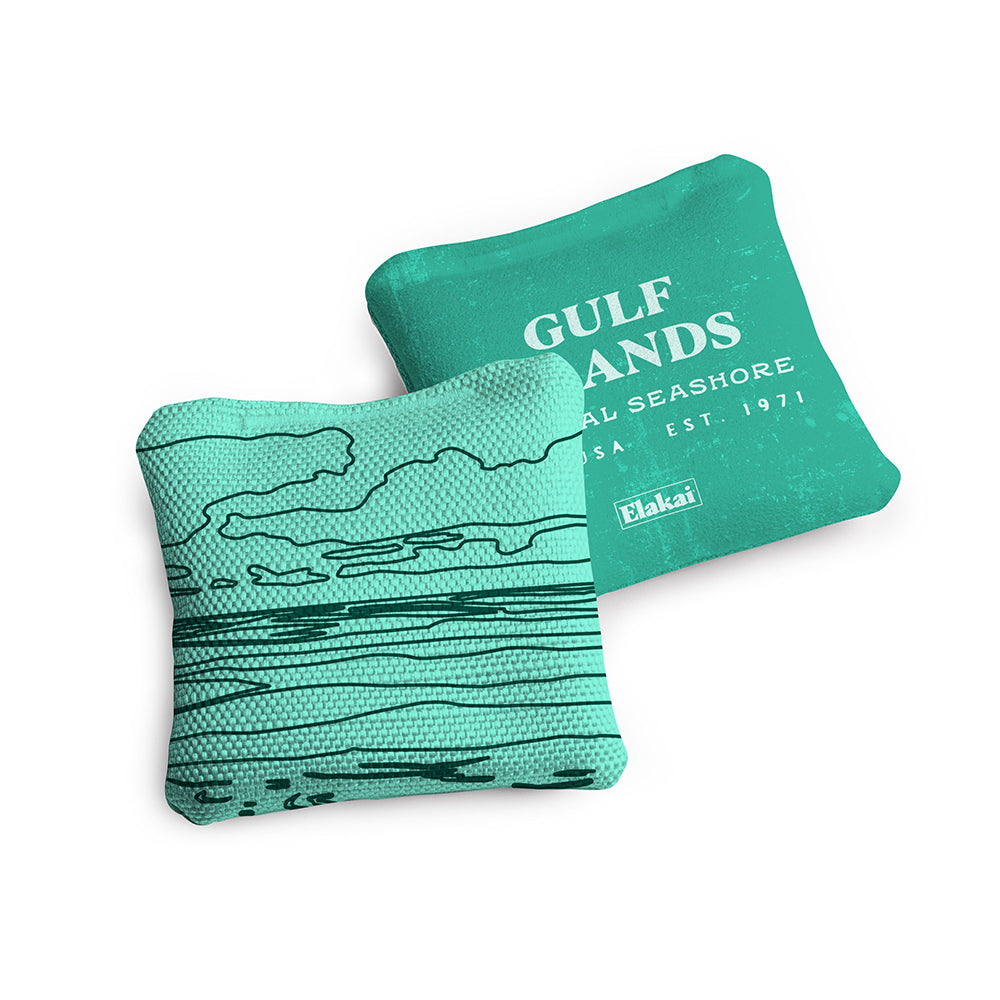 Two teal coasters with a coastal design and 'Gulf Sands' text on a white background