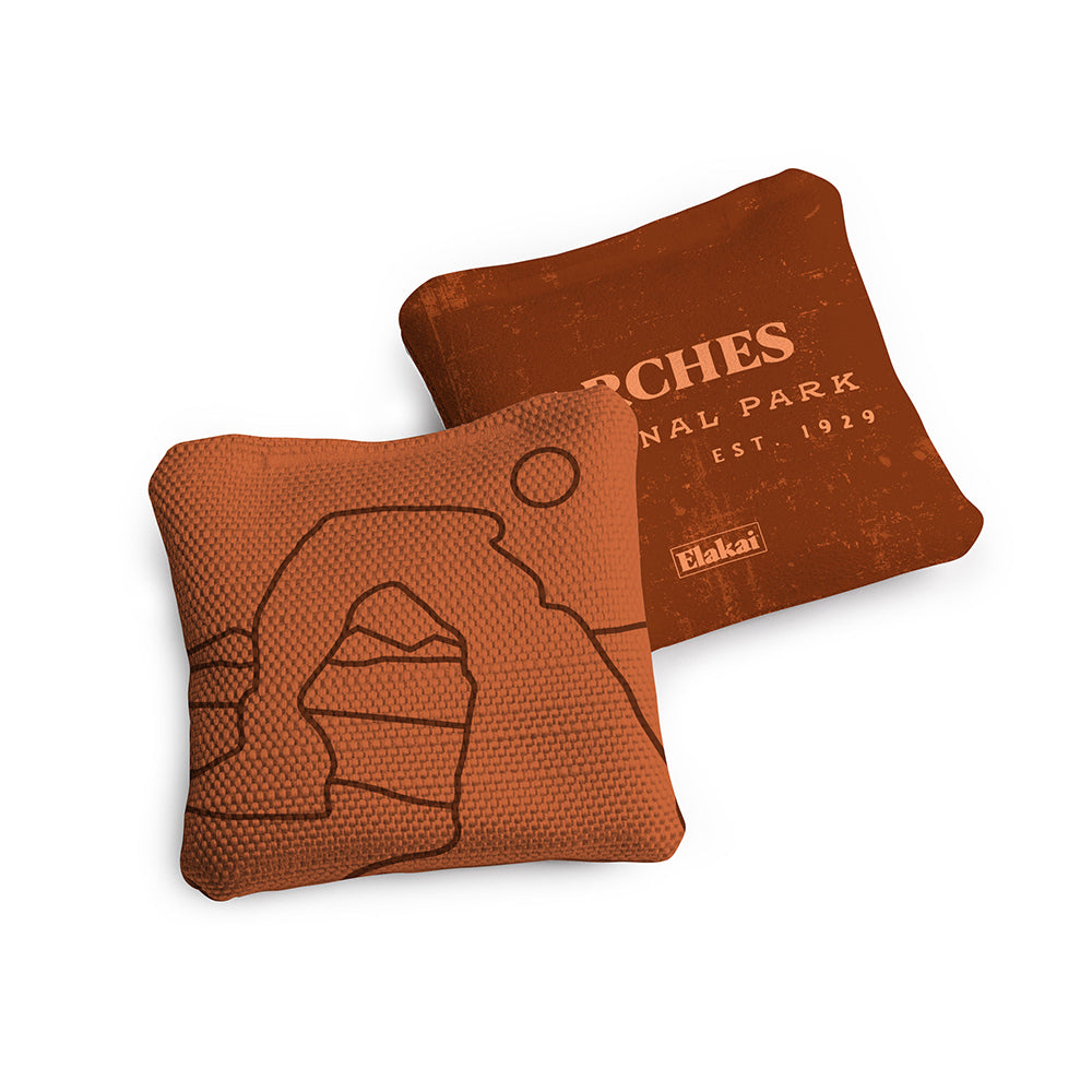 Two brown bean bags with Arches National Park design on a white background