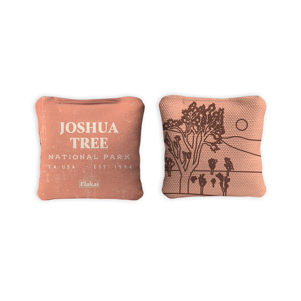 Two decorative pillows with 'Joshua Tree National Park' text and illustrations on a white background.
