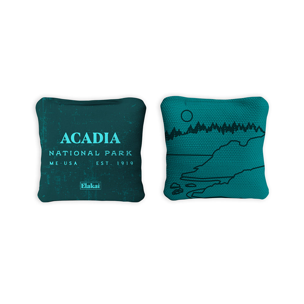 Two teal pillows with 'Acadia National Park' text and design on a white background