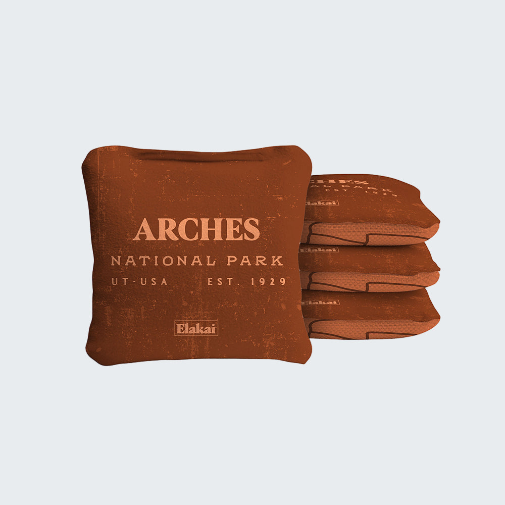 Brown pillow with 'Arches National Park' text on a white background