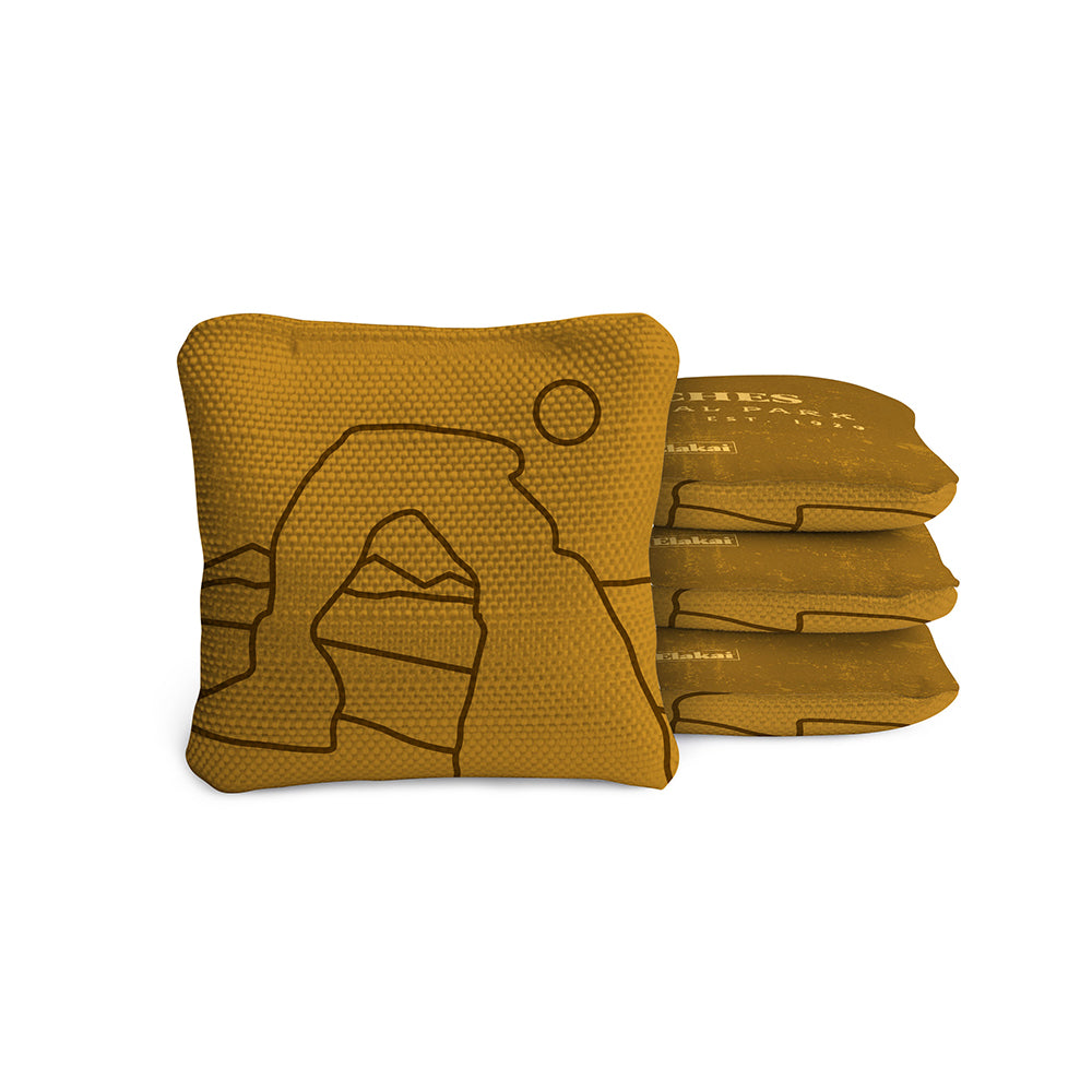 Stack of mustard yellow bean bags with a design on a white background