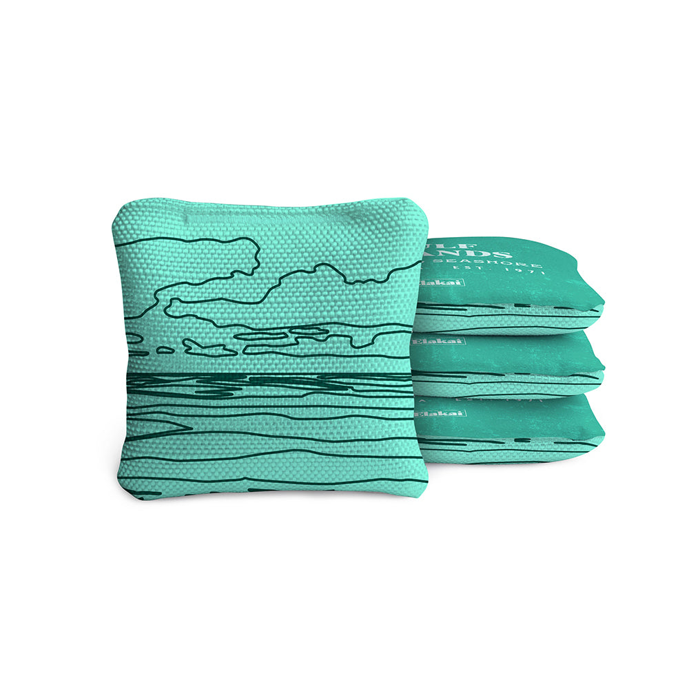 Stack of teal cornhole bags with a pattern on a white background