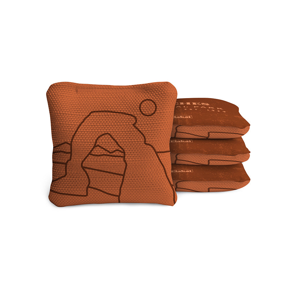 Set of brown cornhole bags with a logo on a white background