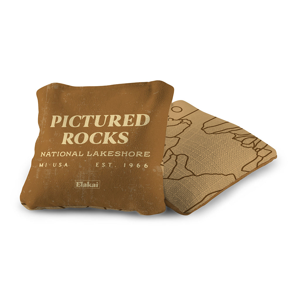 Brown pillow with 'Pictured Rocks National Lakeshore' text on a white background