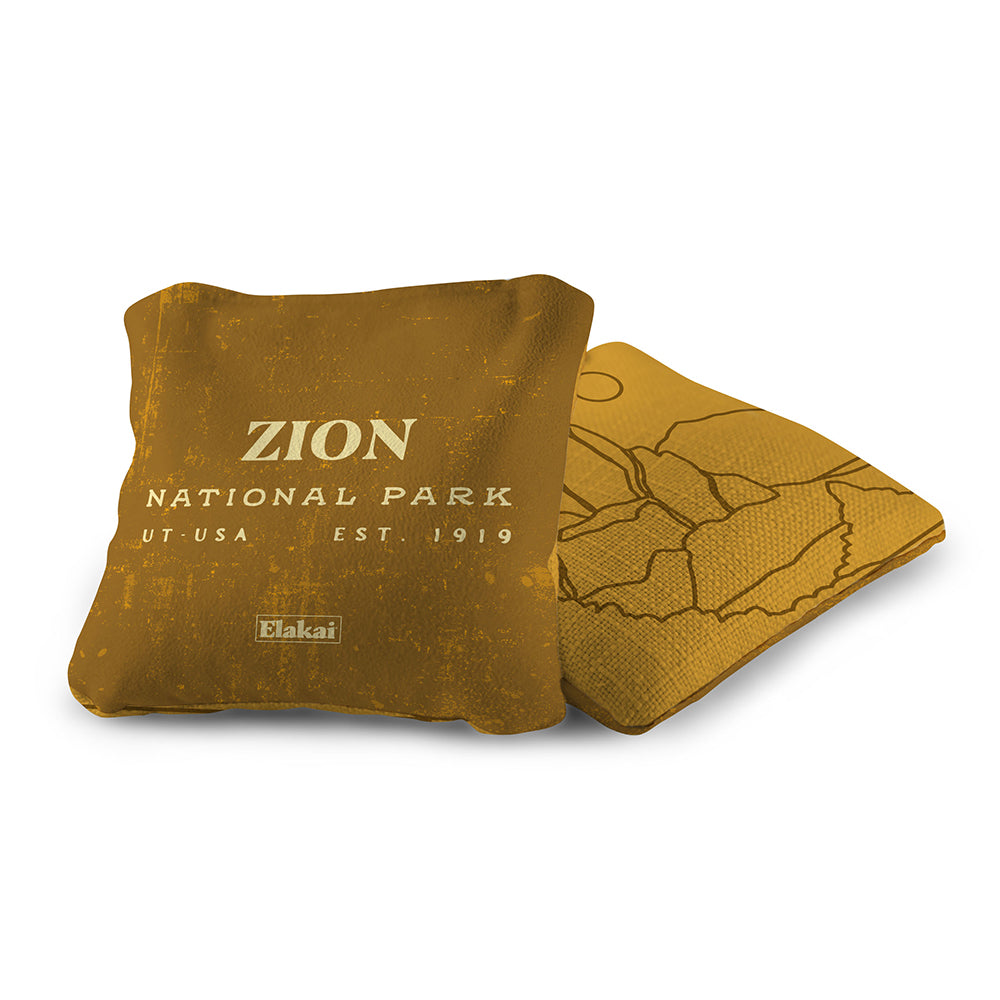 Brown pillow with 'Zion National Park' text on a white background