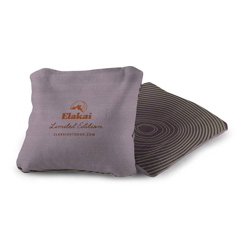 Gray pillow with Elakai branding on a white background