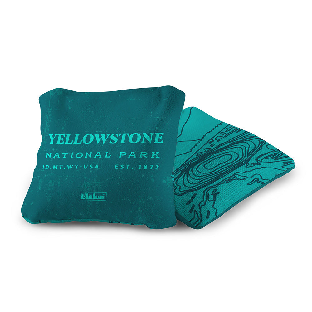 Teal pillow with 'Yellowstone National Park' text on a white background
