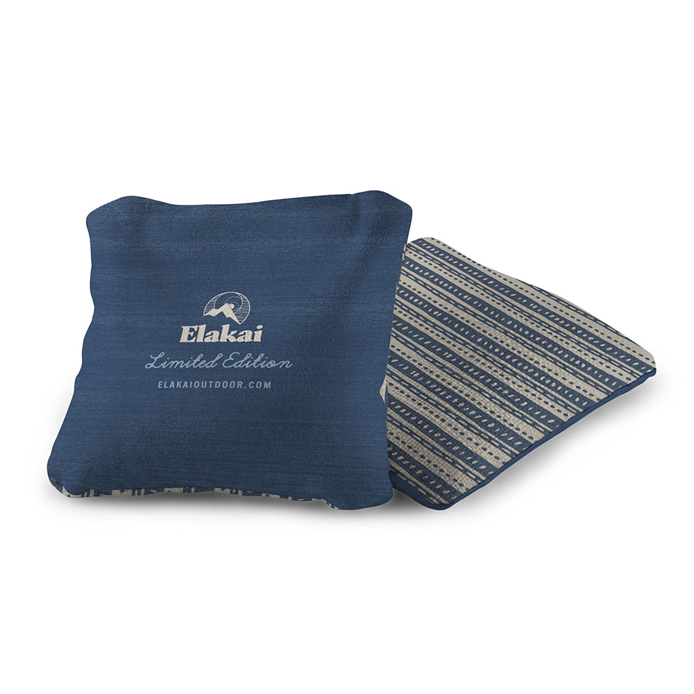 Blue folded blanket with Elakai branding on a white background
