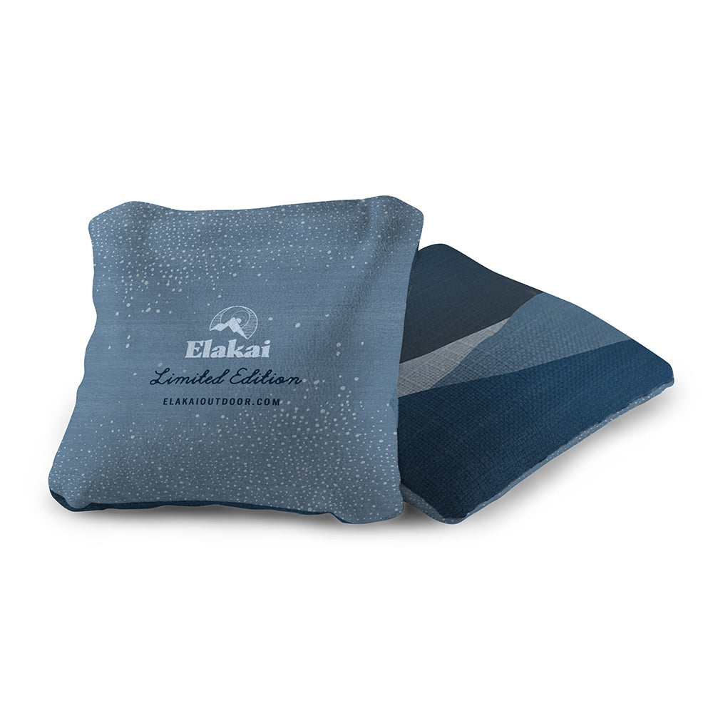 Blue pillow with 'Elakai' branding on a white background