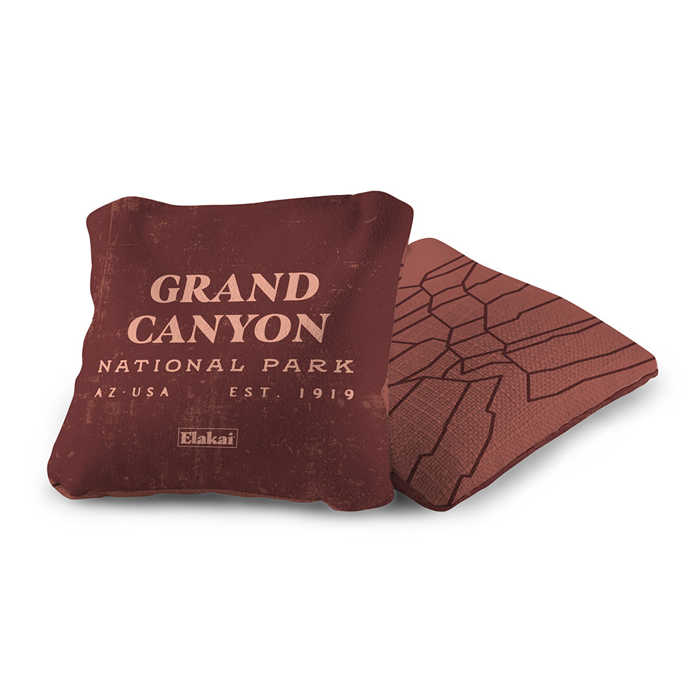 Brown pillow with 'Grand Canyon National Park' text and a matching coaster on a white background