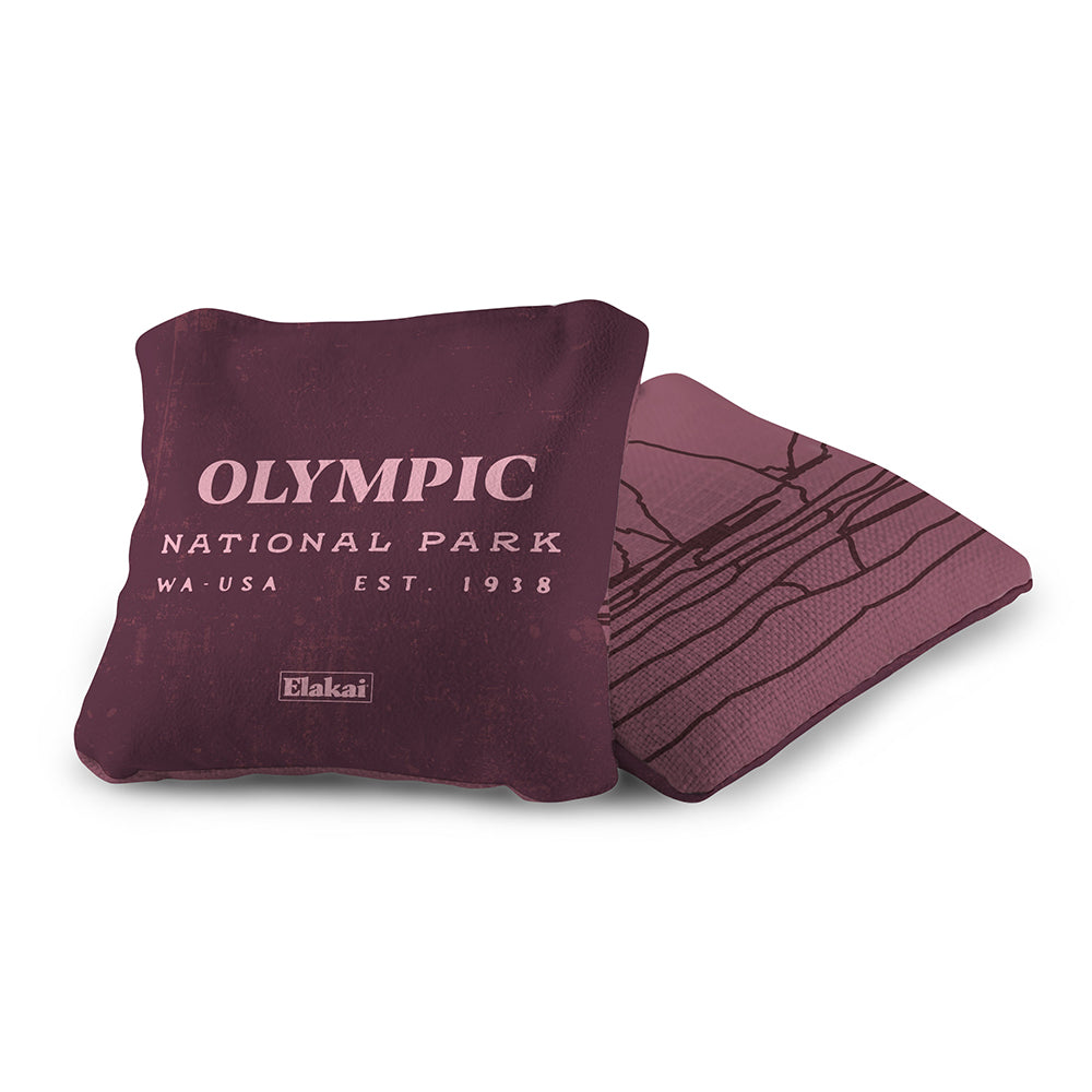 Maroon pillow with 'Olympic National Park' text on a white background