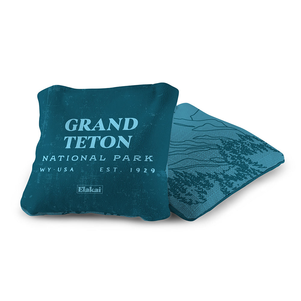 Teal pillow with 'Grand Teton National Park' text on a white background