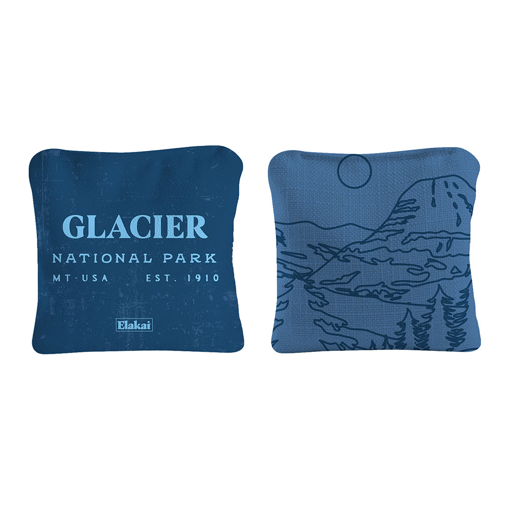 Two blue pillows with 'Glacier National Park' text and landscape design on a white background