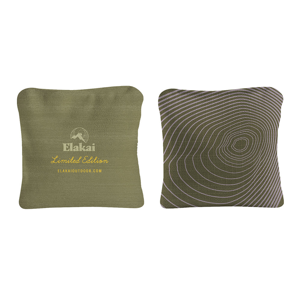 Two green pillows, one with Elakai branding and the other with a wavy pattern, on a white background.