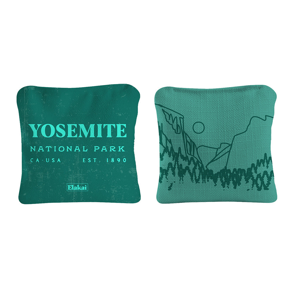 Two green pillows with Yosemite National Park text and design on a white background