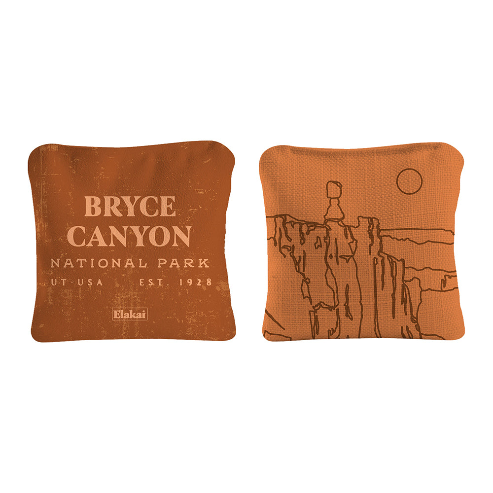 Two orange pillows with Bryce Canyon National Park text and illustration on a white background