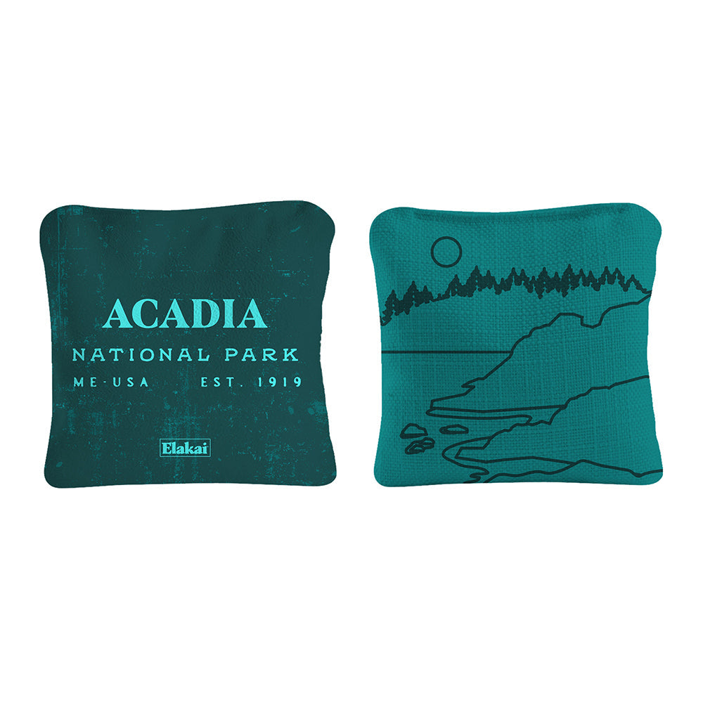 Two teal pillows with 'Acadia National Park' text and design on a white background