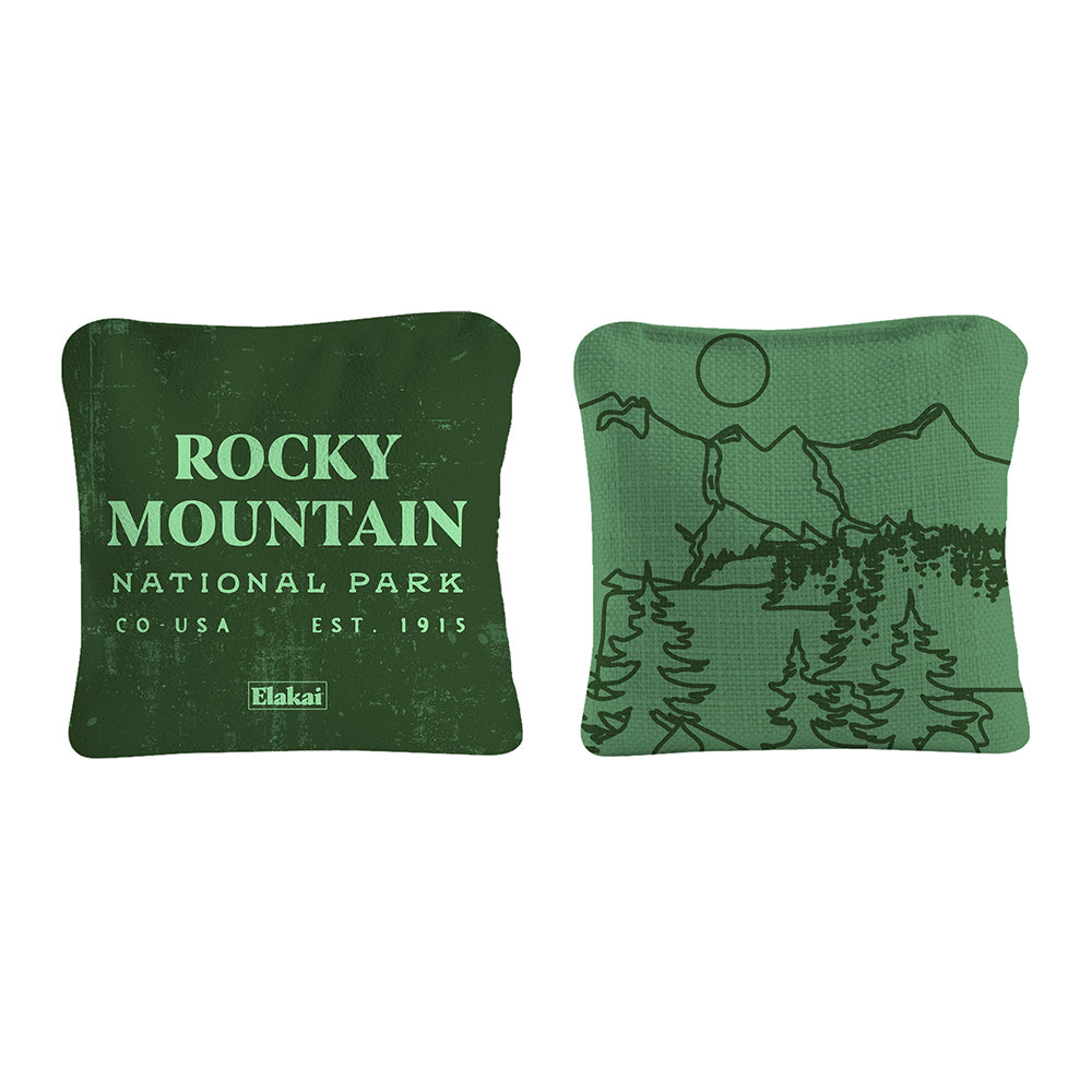 Two green pillows with 'Rocky Mountain National Park' text and mountain design on a white background.