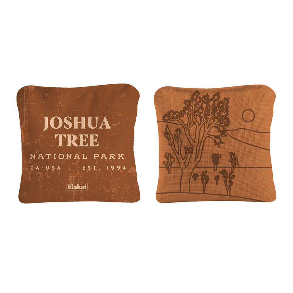 Two brown pillows with 'Joshua Tree National Park' text and tree design on a white background
