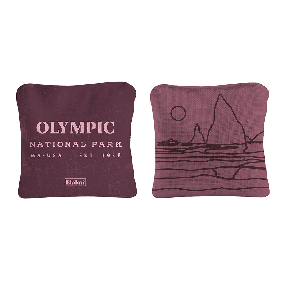Two maroon pillows with 'Olympic National Park' text and mountain design on a white background