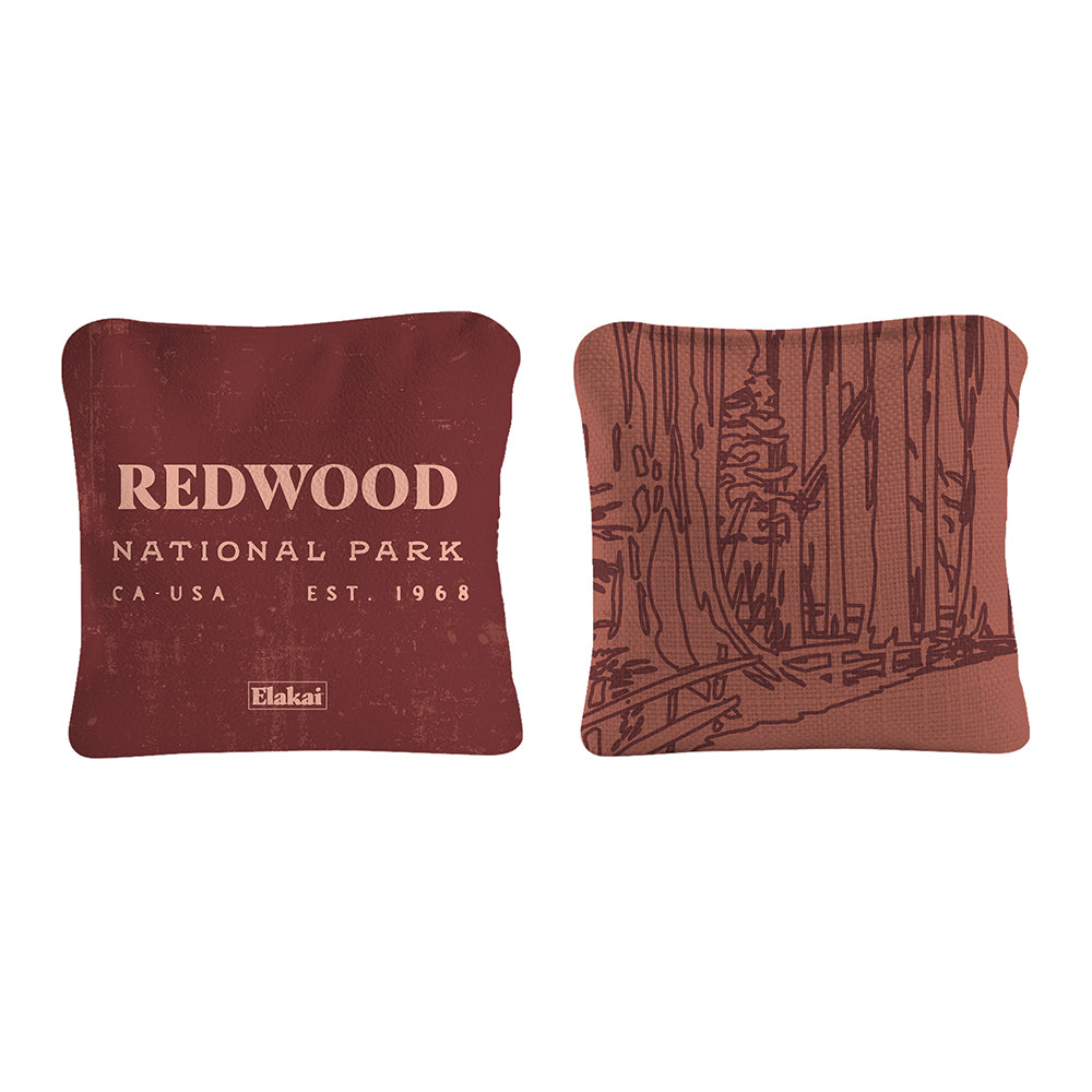 Two pillows, one with 'Redwood National Park' text and the other with a forest design, on a white background.