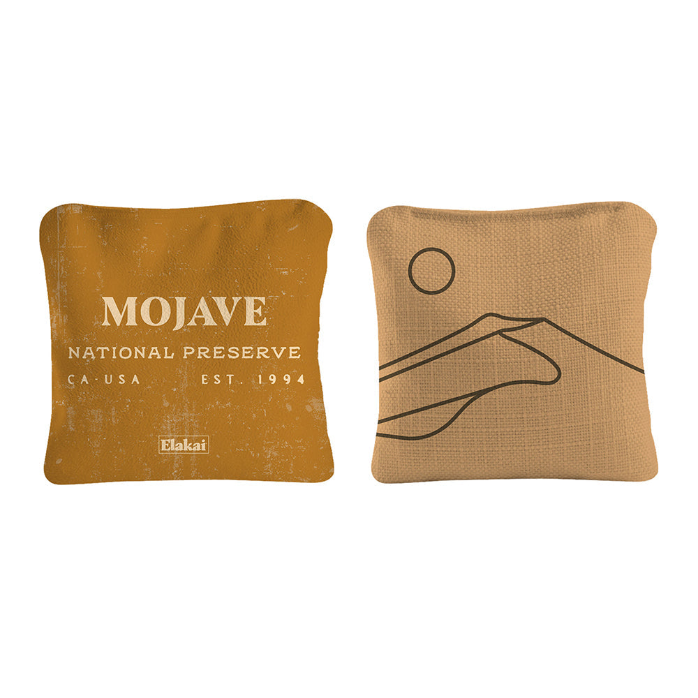 Two decorative pillows with 'Mojave National Preserve' text and a hand design on a white background.