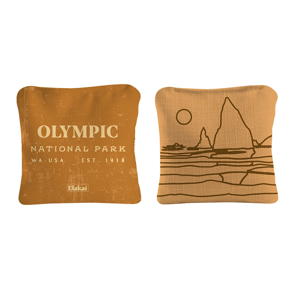 Two brown pillows with 'Olympic National Park' text and mountain design on a white background
