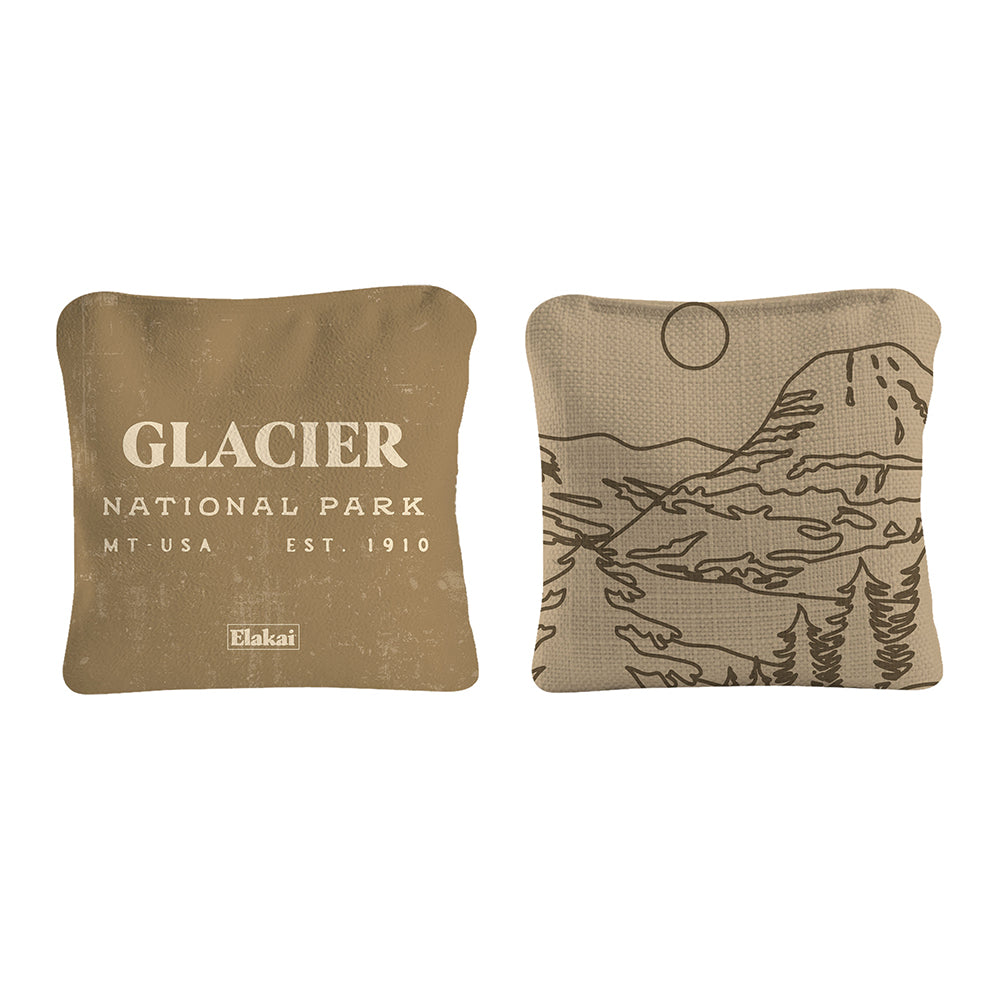 Two brown pillows with 'Glacier National Park' text and landscape design on a white background