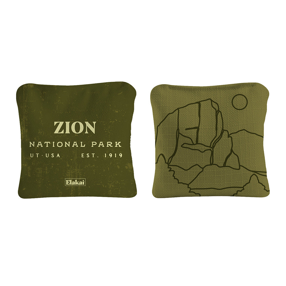 Two green pillows with Zion National Park text and map design on a white background