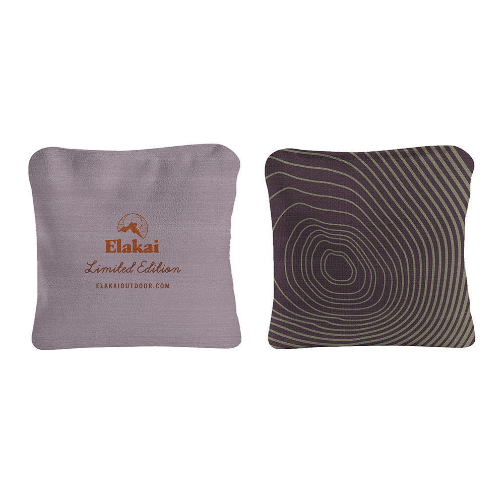 Two pillows, one with Elakai branding and the other with a circular pattern, on a white background.