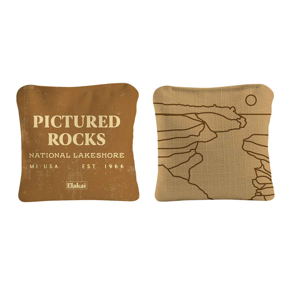 Two decorative pillows with 'Pictured Rocks National Lakeshore' text and map design on a white background.