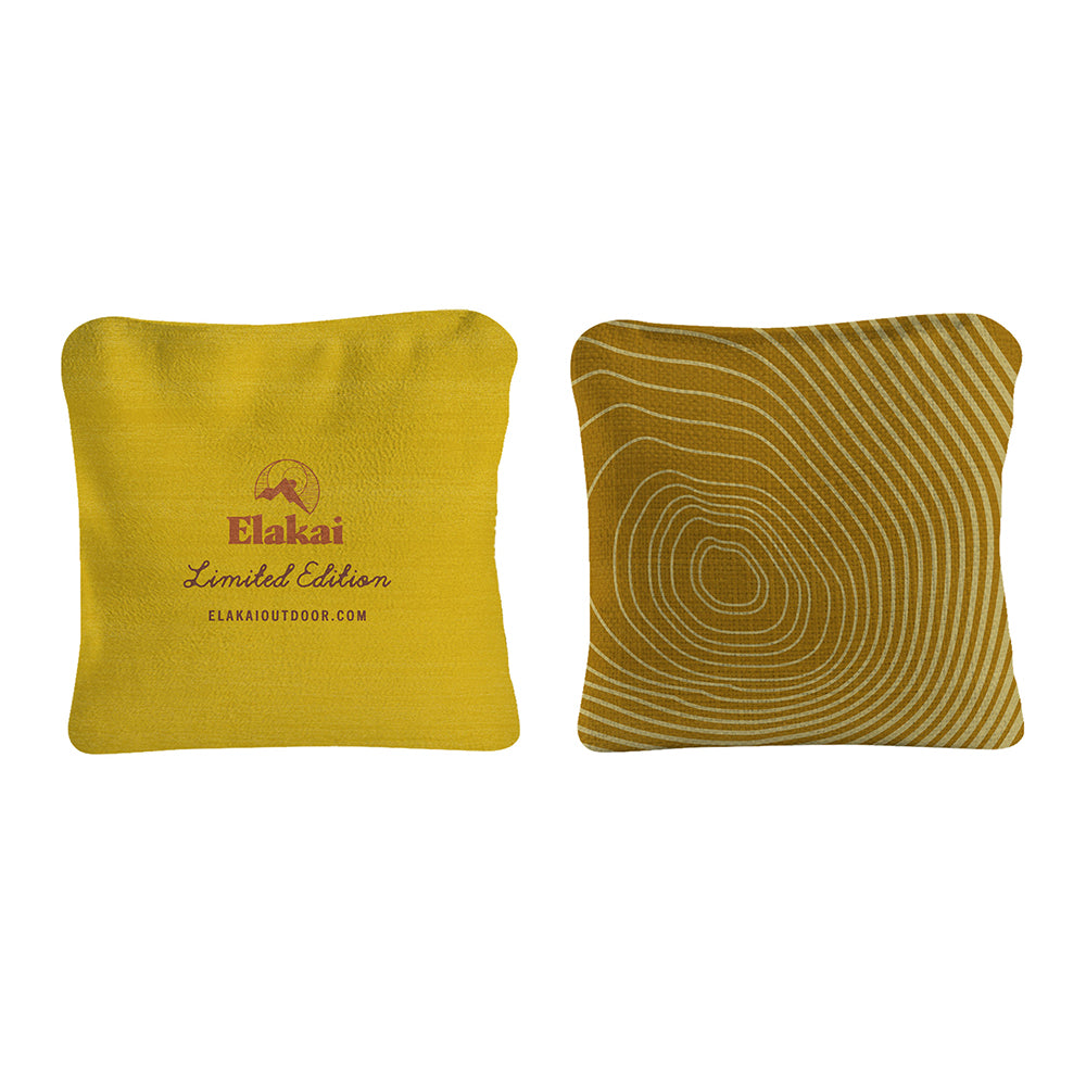 Two yellow pillows, one with a textured pattern and the other with branding, on a white background.