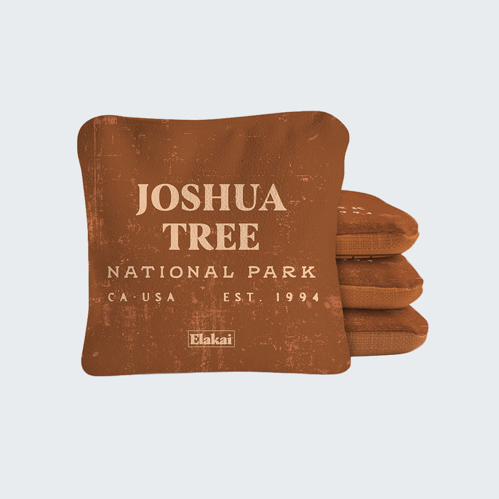 Brown pillow with 'Joshua Tree National Park' text on a white background