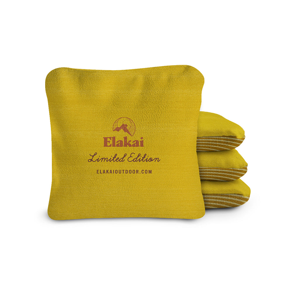 Yellow fleece blanket with Elakai branding on a white background