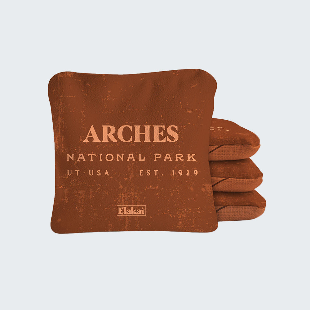 Brown pillow with 'Arches National Park' text on a white background
