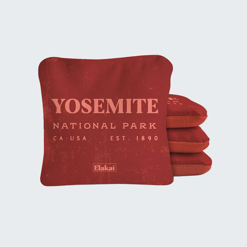 Red pillow with 'Yosemite National Park' text on a white background